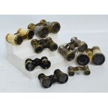 A collection of various opera glasses including a bone covered pair, a mother of pearl pair,