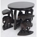 A nest of five ebonised decorative elephant occasional tables, the main oval top 73 x 54cm.