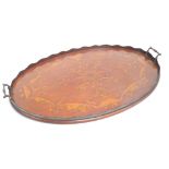 An Edwardian oval mahogany tray with specimen wood inlay and wavy gallery, with twin handles,