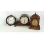 A 1930s oak dome topped mantel clock, the circular dial set with Roman numerals, width 39cm,