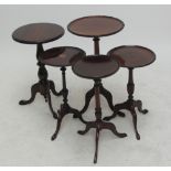 Five reproduction mahogany tripod occasional tables, one with inlaid central panel.