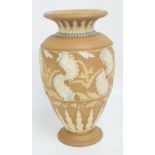 A Doulton Lambeth Silicon brown glazed relief moulded baluster vase decorated with paisley style