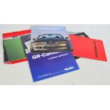 A collection of car catalogues including Saab 9000, Rover 3500, BMW 73 Roadster,