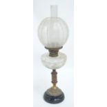 A late 19th/early 20th century oil lamp with clear cut glass reservoir on glass fluted stem with