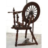 A mid Victorian oak spinning wheel in need of restoration, height 129cm.