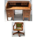 An oak roll top writing bureau with fitted interior with drawers and pigeonholes,
