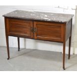 An Edwardian mahogany inlaid wash stand with marble top on tapering legs terminating in castors,