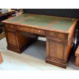 A reproduction Bevan-Funnell eight drawer mahogany and green leather inset pedestal desk,