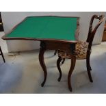 A 19th century rosewood fold-over card table with carved knee cabriole legs and further carved