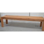 A long rectangular pitch pine dining table on block supports, 300 x 78cm.