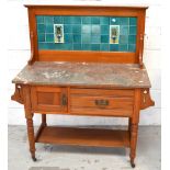 An Edwardian walnut marble top washstand with turquoise tiled splashback with peacock decoration,