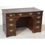 An early 20th century oak kneehole office desk with faux leather insert,