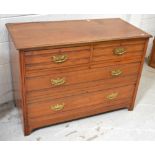 A walnut two-over-two chest of drawers on bracket feet with brass handles, length 107cm,