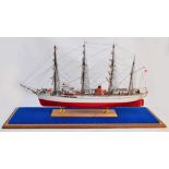 A Nipponmaru 1/100 scale model of a four masted vessel, in glazed case, length of case 115cm.