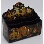 A papier mâché Japanese style lacquered stationery rack painted with various figural scenes to