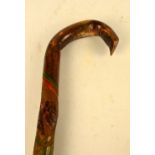 A 1930s naïve walking stick with coloured and incised decoration depicting animals alternating with