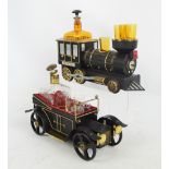 Two novelty musical drinks caddies, each with a decanter and shot glasses,