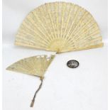 A bone framed lace fan, length 35cm, a further smaller similar pierced example,