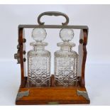 An oak and white metal mounted Betjemann's of London patterned tantalus with lock to one side