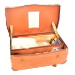 A mid 20th century First Aid case containing various including a set of graduated splints, bandages,