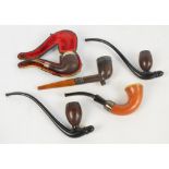A collection of pipes including three hallmarked silver mounted examples,