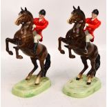 A pair of Beswick figures; both model 868, huntsman on a rearing horse on a green grassy plinth,