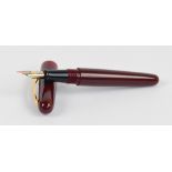 A Bexley red bodied fountain pen with 18ct two tone gold nib, length 13.8cm.