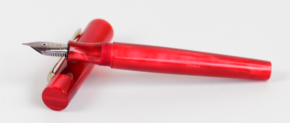 An Edison Pen Co "Hudson" fountain pen with ruby body and nib inscribed "EF", length 15.3cm.