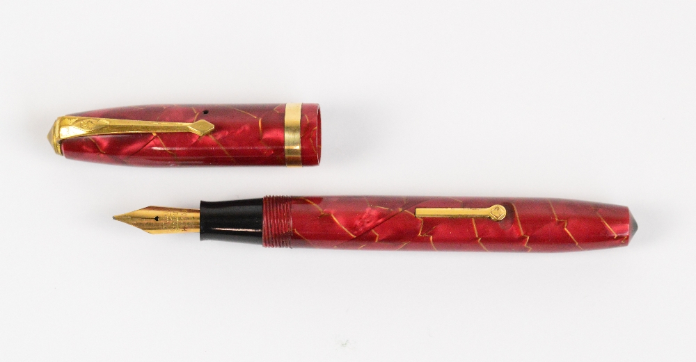 A Conway Stewart 84 fountain pen in gold veined rose coloured body with gold plated trim, length 11. - Image 2 of 3