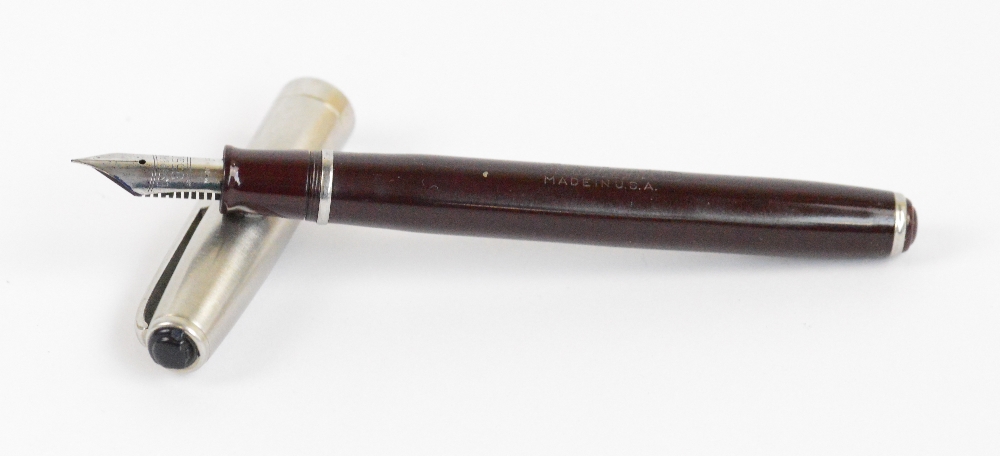 An Esterbrook fountain pen with maroon body and steel cap, length 13cm.