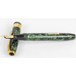 A Conway Stewart 27 fountain pen with green and black striated body and 14ct yellow gold cap,