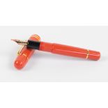 A Bexley Poseidon Magnum fountain pen with orange body, plated mounts and 18ct two tone gold nib,