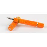 A Delta Gallery "Dolce Vita" mottled orange bodied fountain pen with 14ct white gold nib and