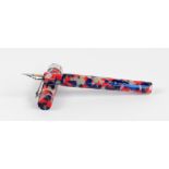 A Conklin Endura fountain pen with mottled blue, red and white body, and nib inscribed "Conklin,