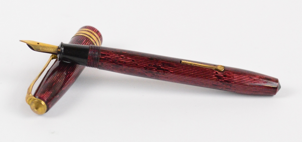 A Conway Stewart 36 fountain pen with maroon vertical striped body and 14ct yellow gold nib,
