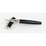 A Caran d'Ache fountain pen with black body and plated mounts and 18ct white gold nib, length 13.