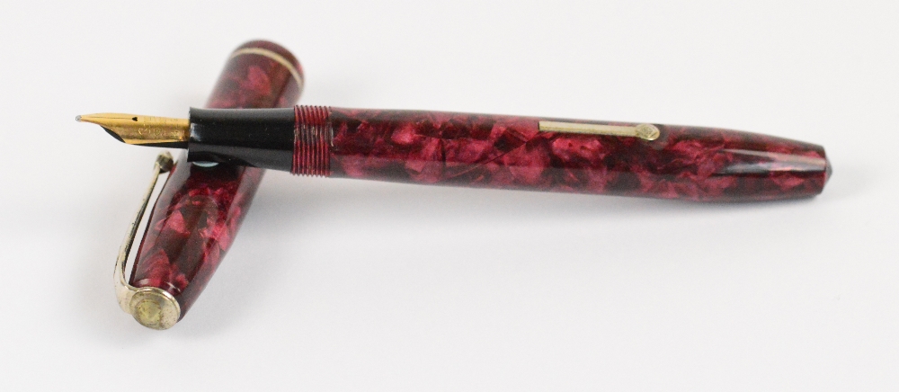 A Conway Stewart 75 fountain pen with rose pearl marbled body and 14ct yellow gold nib, length 12.