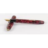 A Conway Stewart 75 fountain pen with rose pearl marbled body and 14ct yellow gold nib, length 12.