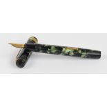A Conway Stewart no.55 fountain pen with green marbled body and 14ct gold duro nib, length 13cm.