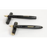 Two "Blackbird" Mabie Todd fountain pens; one with ribbed decoration to the black body,