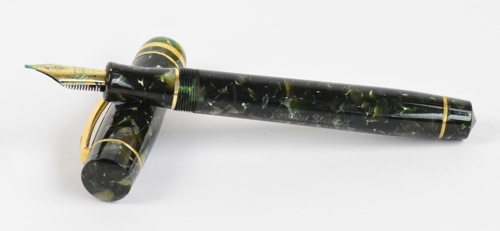 A Conway Stewart "Wellington" fountain pen with mottled green body and 18ct hallmarked yellow gold