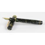 A Conway Stewart "Wellington" fountain pen with mottled green body and 18ct hallmarked yellow gold