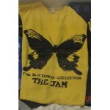 An original T-Shirt, The Butterfly Collector, printed in black on a yellow ground.