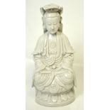 A blanc de Chine figure of seated Guanyin with serene expression,
