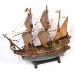 A scratch built scale model of a ship 'Golden Hind' on accompanying stand, length approx 70cm.