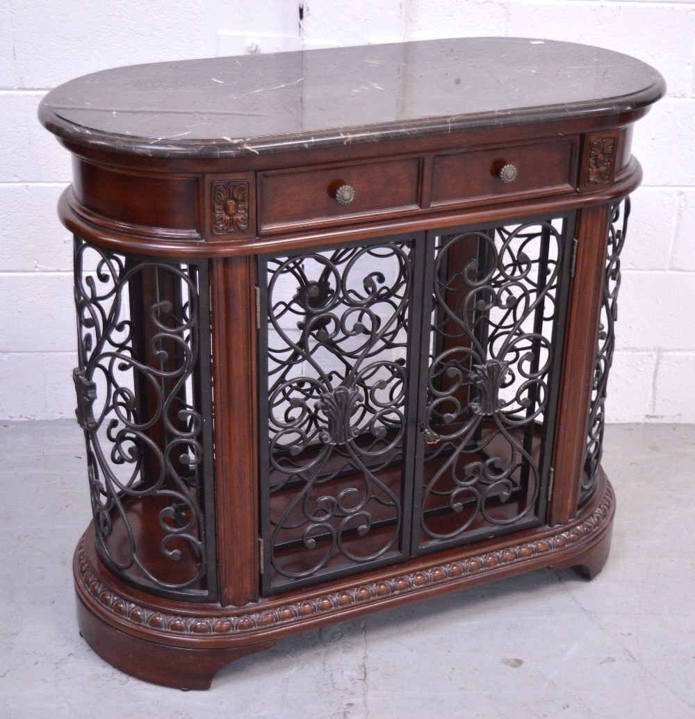 A marble top Howard Miller wine and spirits cabinet of oval form, width 107cm.