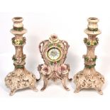 A Capodimonte mantel clock with relief rose decoration, the dial set with Roman numerals,