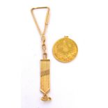 A gold coin with Arabic writing, suspended on a mesh strap with screw clasp, approx 14.7g.
