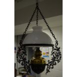 A brass and ebonised metal hanging oil lamp,
