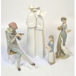 Four Lladró figures, a seated boy playing a flute, a larger pair of nuns,